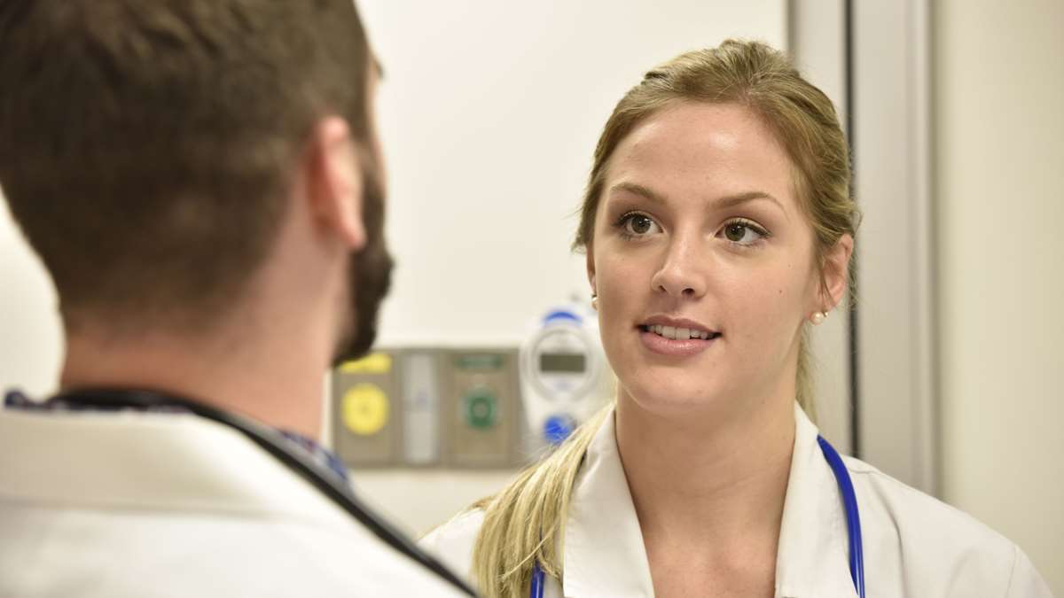 A Nursing student has a discussion with another student