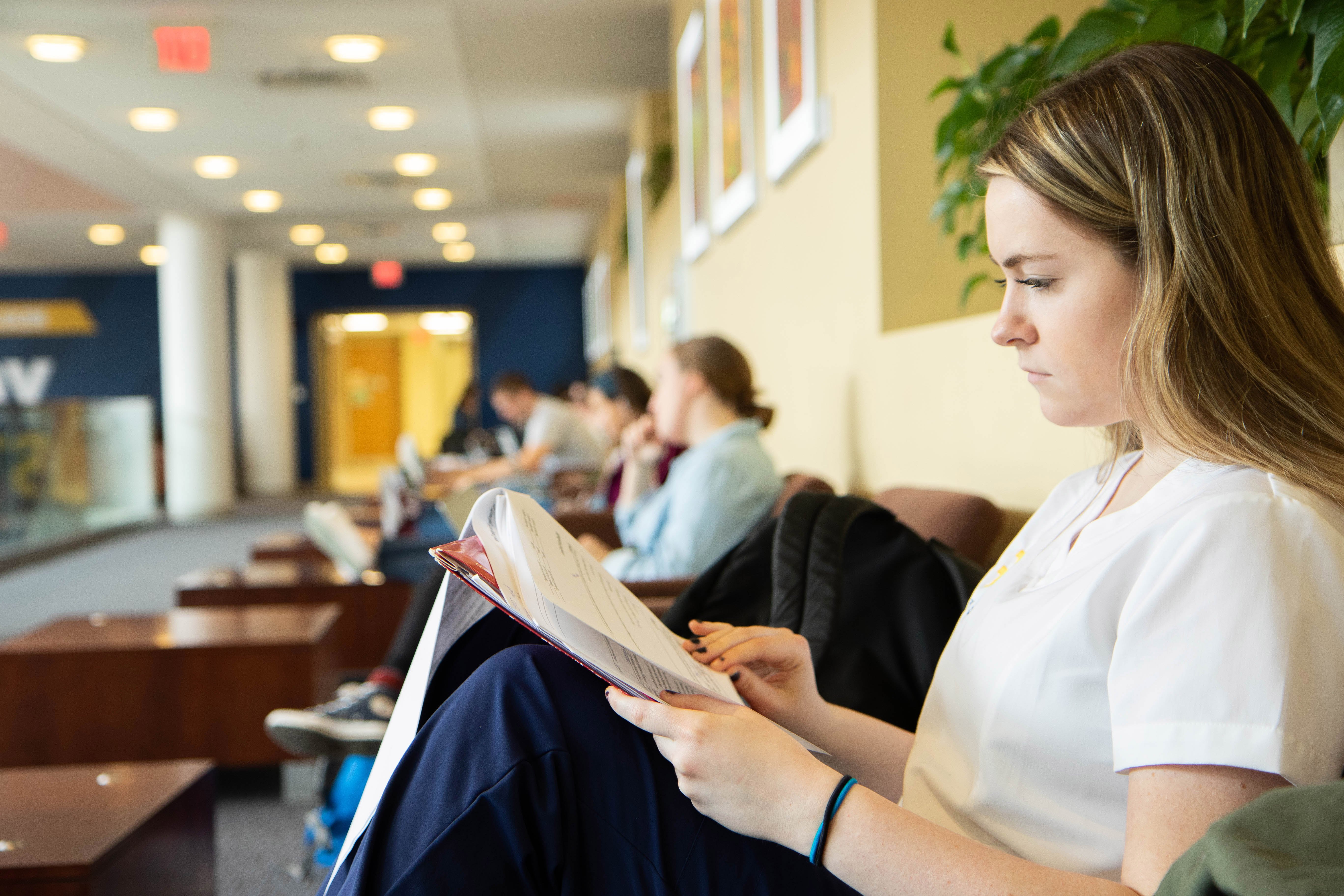A female nursing student studies in the lounge area of the Pylons in the Health Sciences Center, Morgantown.