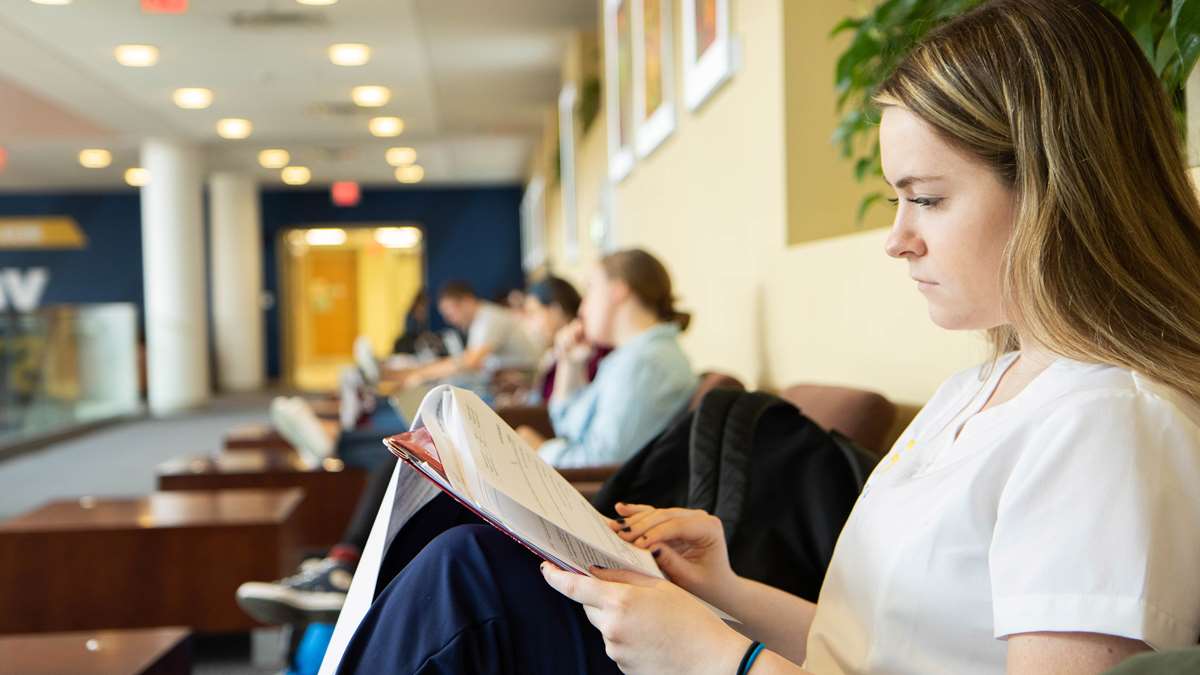 A female nursing student studies in the lounge area of the Pylons in the Health Sciences Center, Morgantown.
