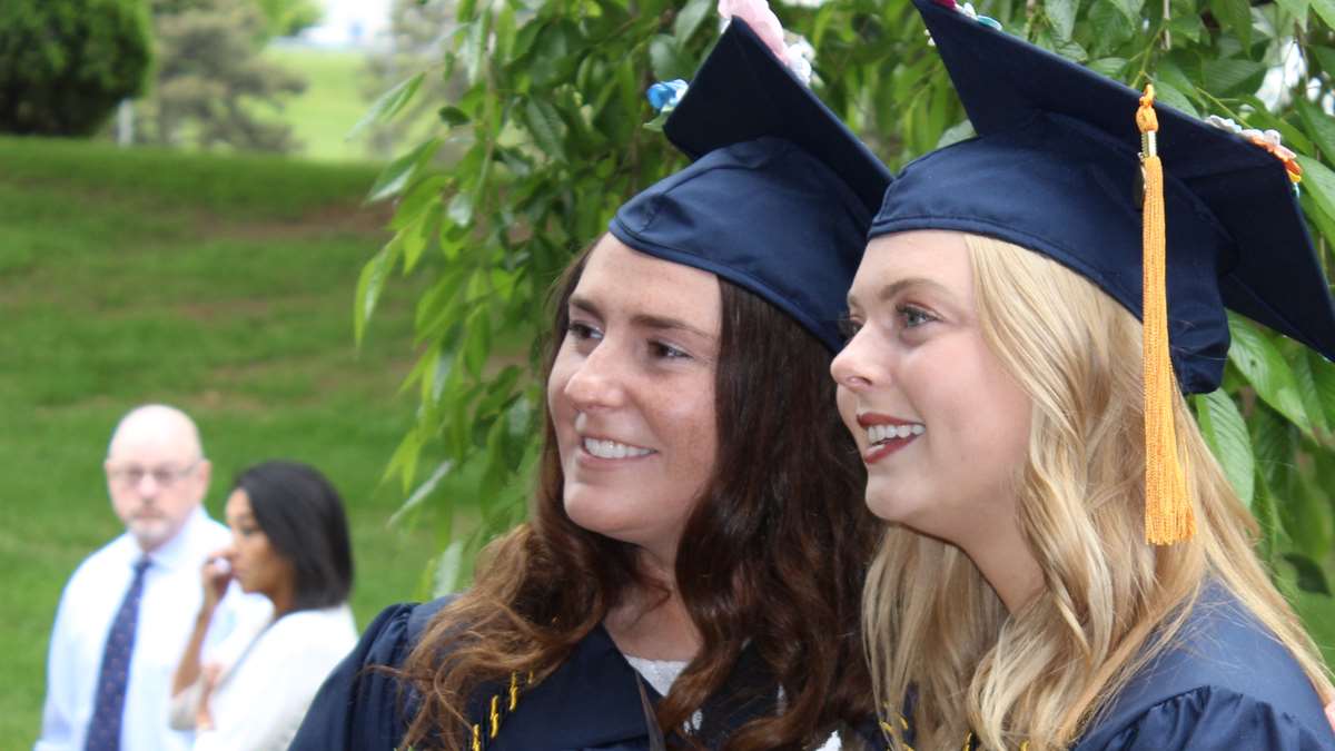 Two students dressed for graduation