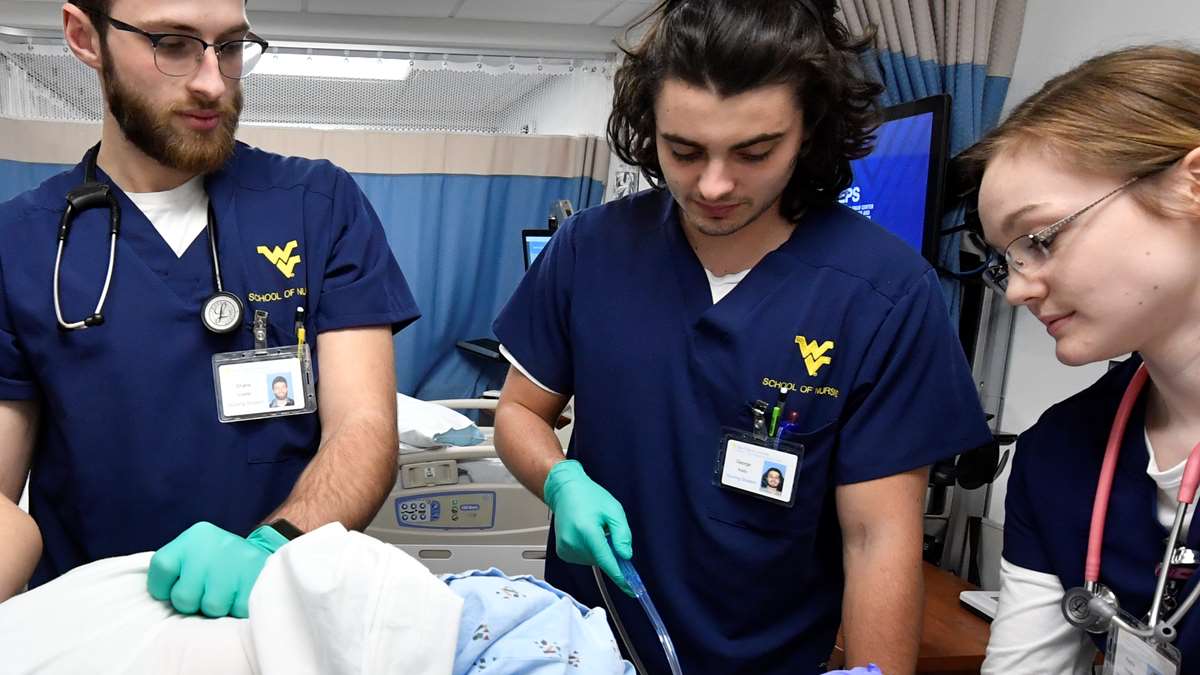 Students learning nursing techniques in a simulation suite.