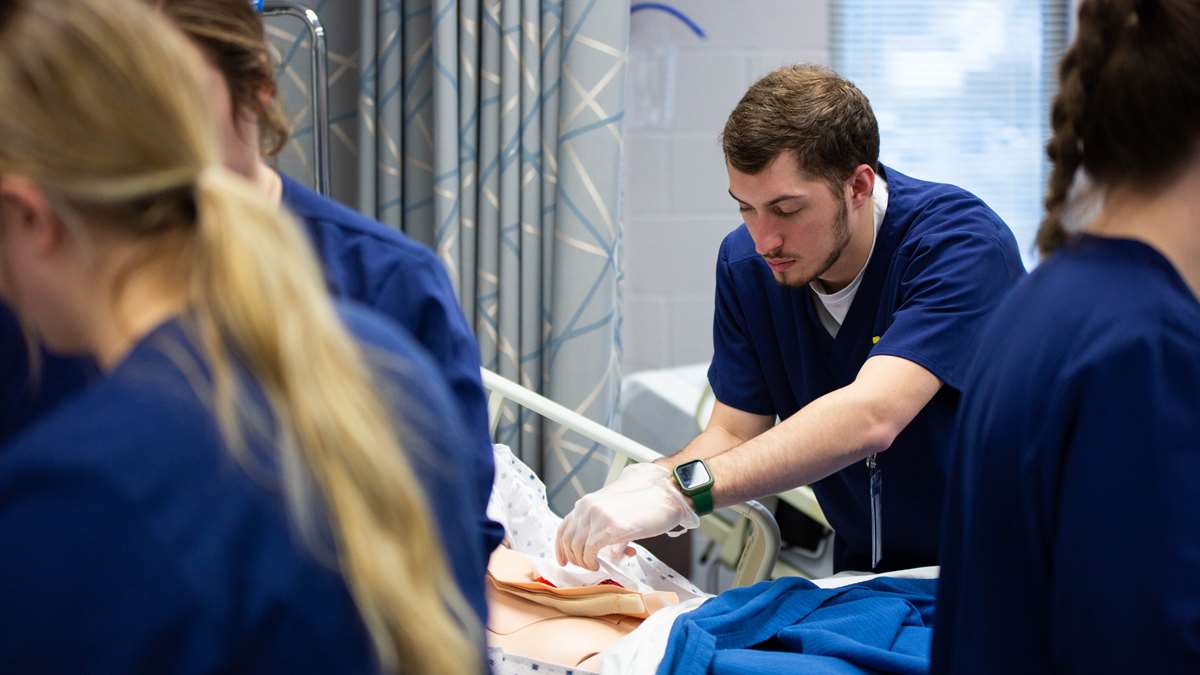 Student nurse works on a manikin in a simulation lab. 